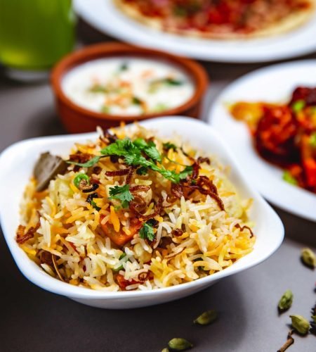 side-view-rice-garnish-with-fried-onion-carrot-greens-chili-pepper-table